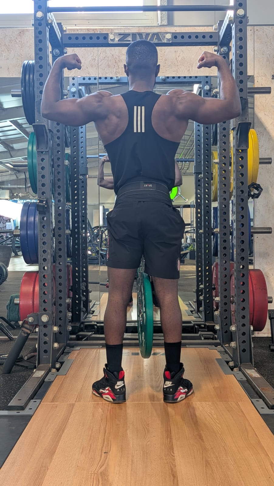 Farai Fitness coach building strength in a squat rack